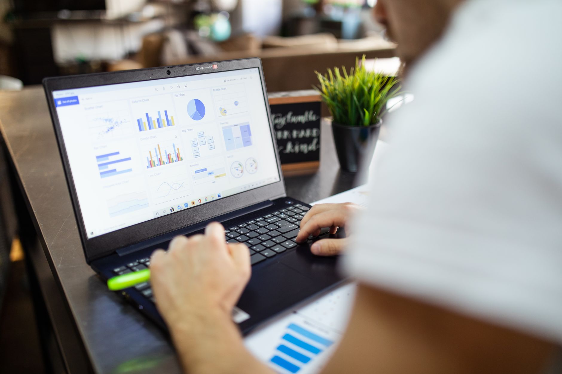 A professional team in a modern office looking at data visualisations on a large monitor, representing a collaborative data analytics environment.
