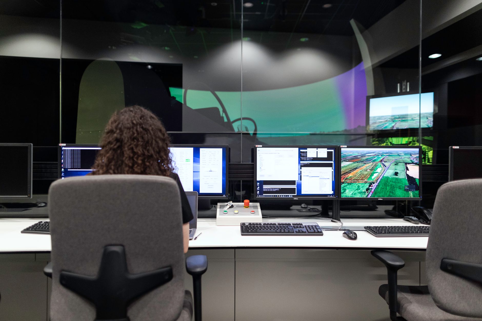 A professional team reviewing sales data charts on a screen in a modern office setting.