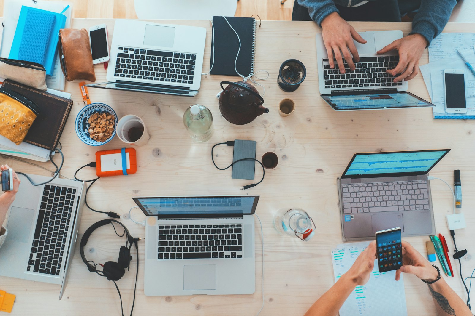 A team working on laptops in a bright meeting space