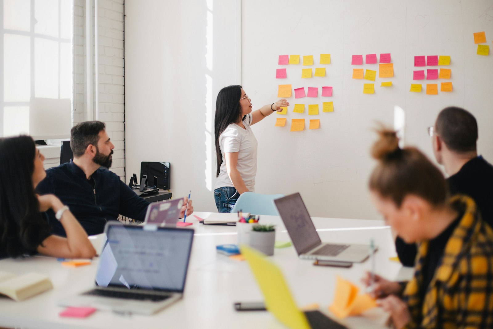A distributed team collaborating around a laptop