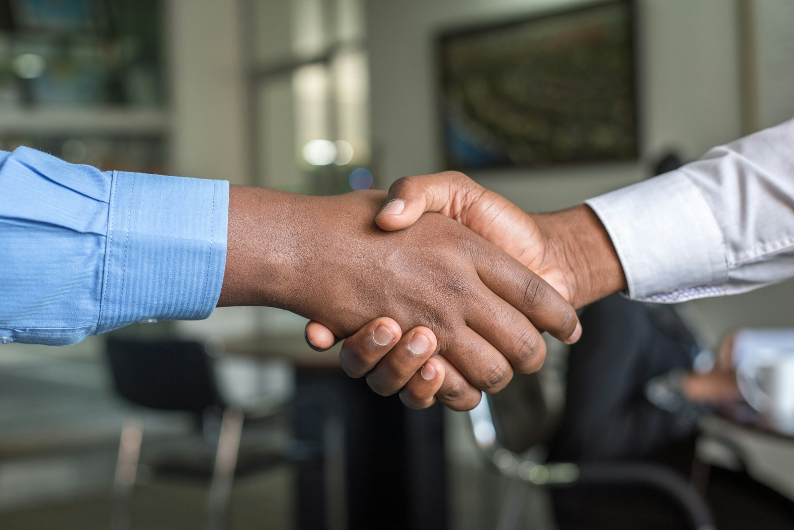 Two colleagues shaking hands at a meeting